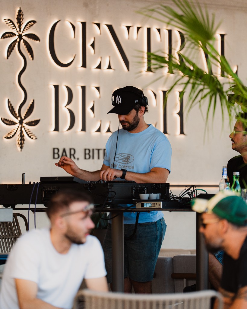 DJ playing under the Central Beach sign, Žnjan beach