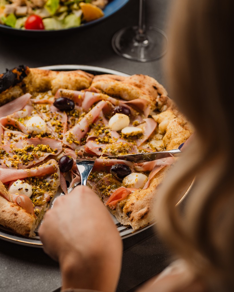 Mortadella and pistachio pizza shared at the table, Central Beach Split