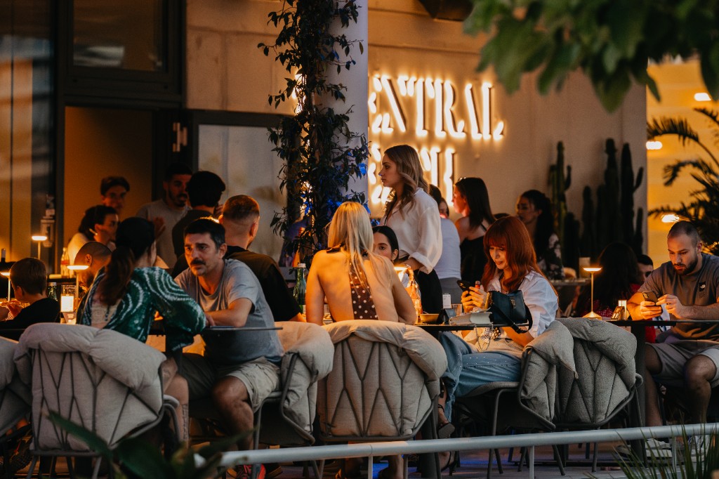 Evening terrace under the lit Central Beach sign, Žnjan